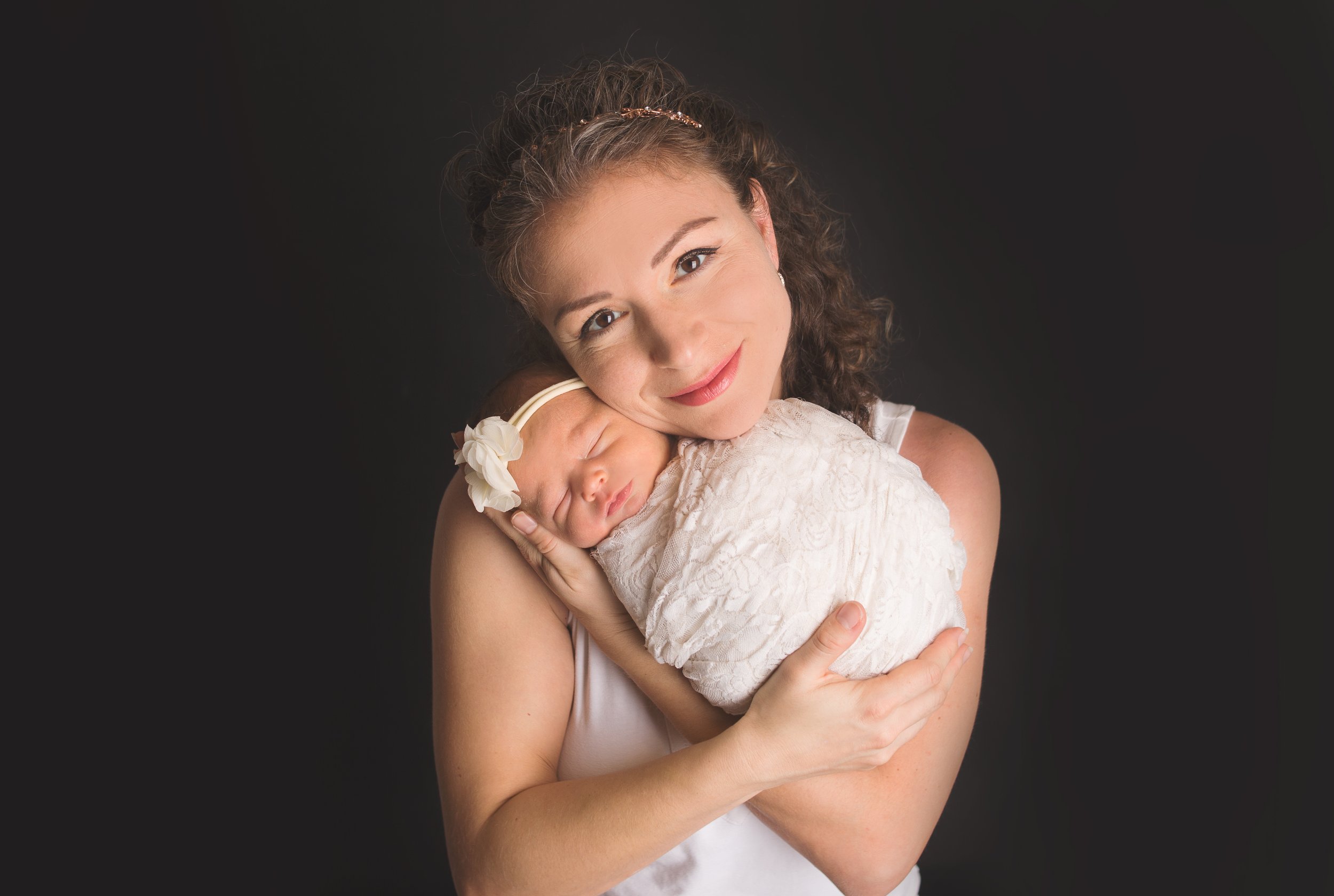mom holding newborn baby in photography studio nashville tennessee