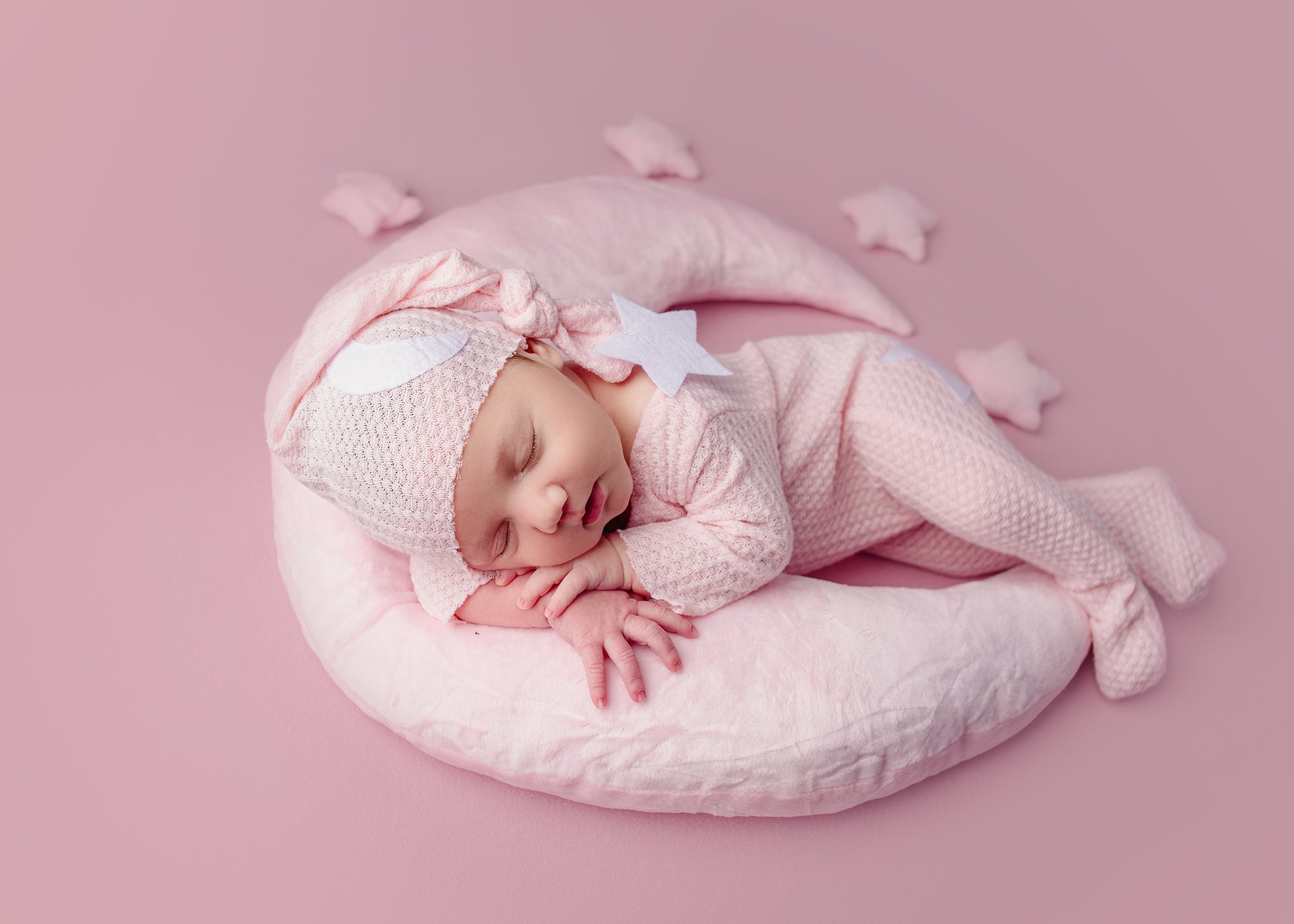 newborn baby girl laying on moon pillow, pink hat, Nashville tennessee