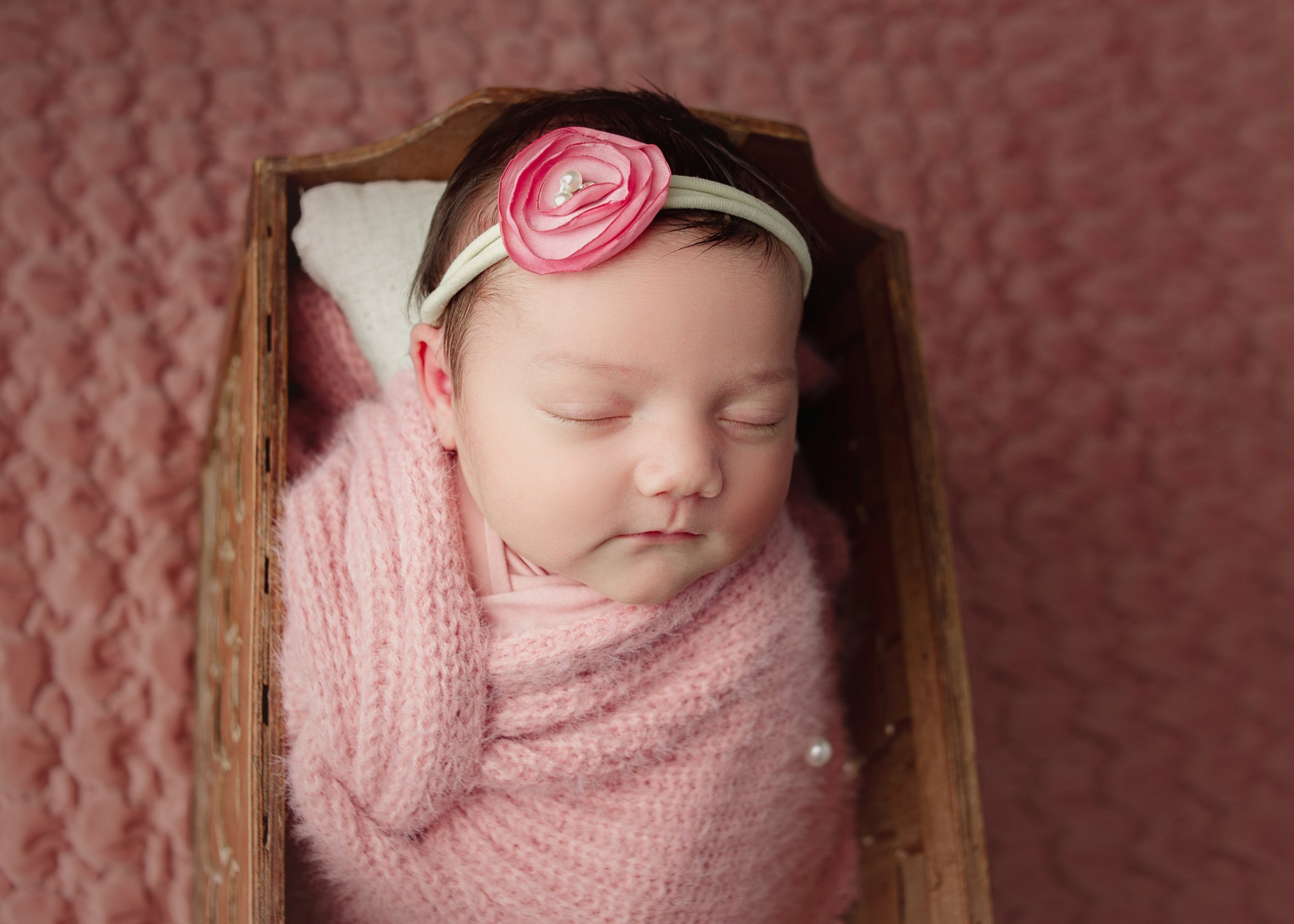 newborn sleeping, pink wrap, flower headband, Nashville Tennessee