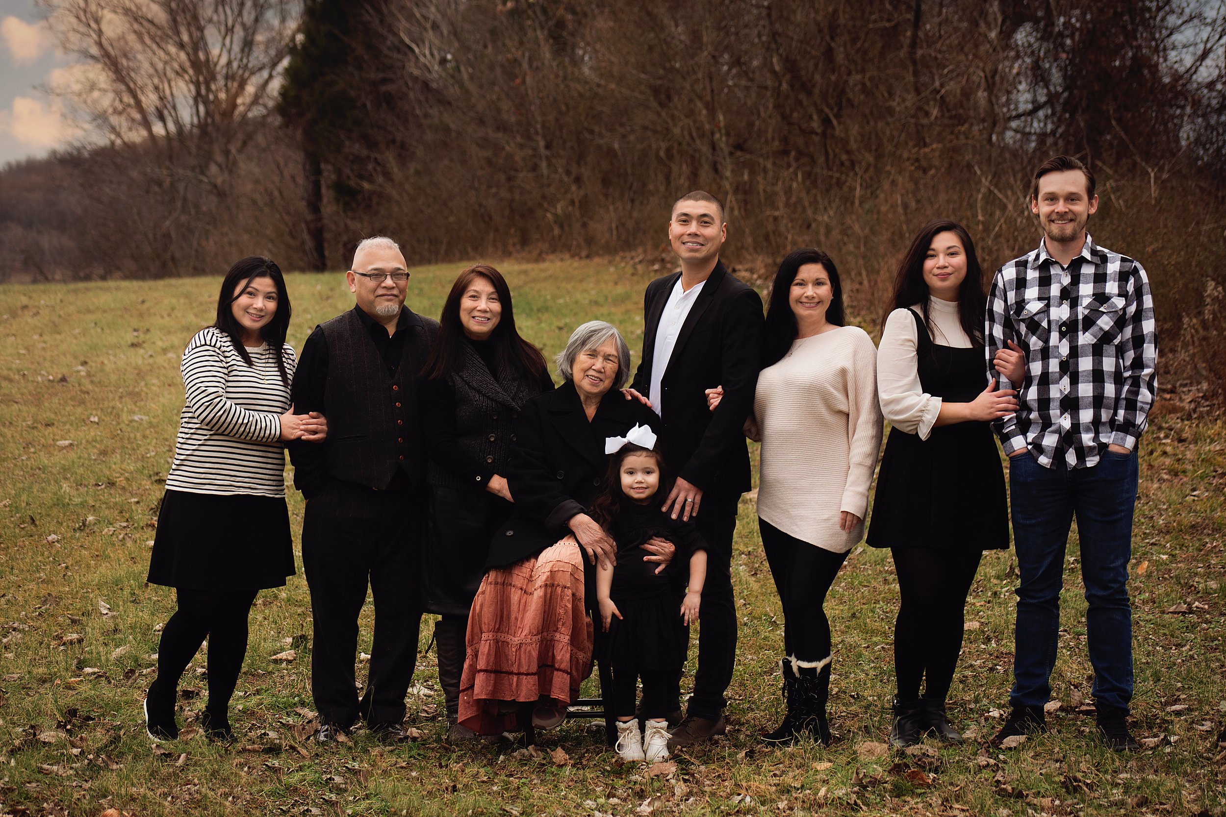 extended family posing for a photo, wearing black and white, in brentwood tennessee