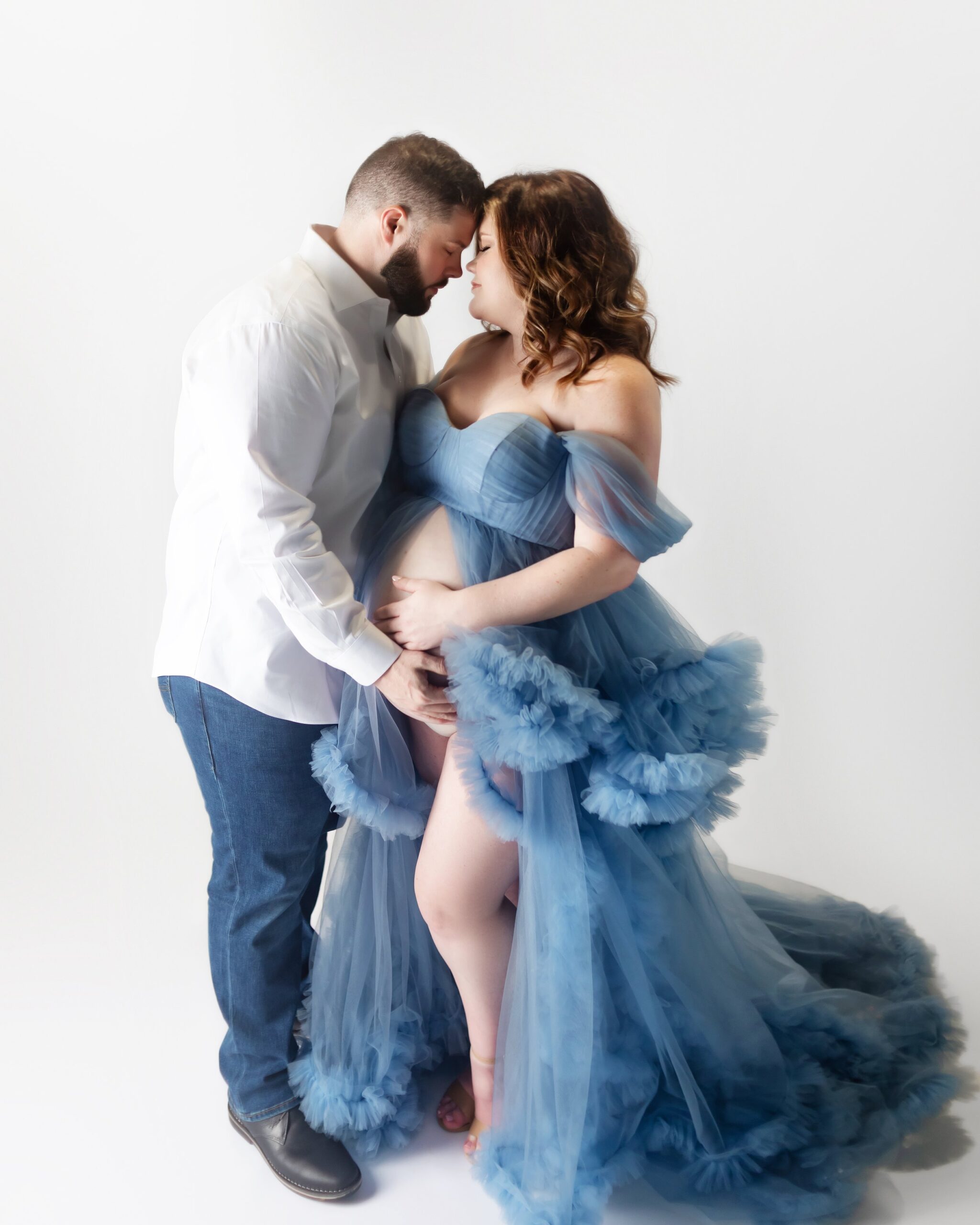 pregnant women wearing a blue gown, during maternity photoshoot in brentwood tennessee photography studio
