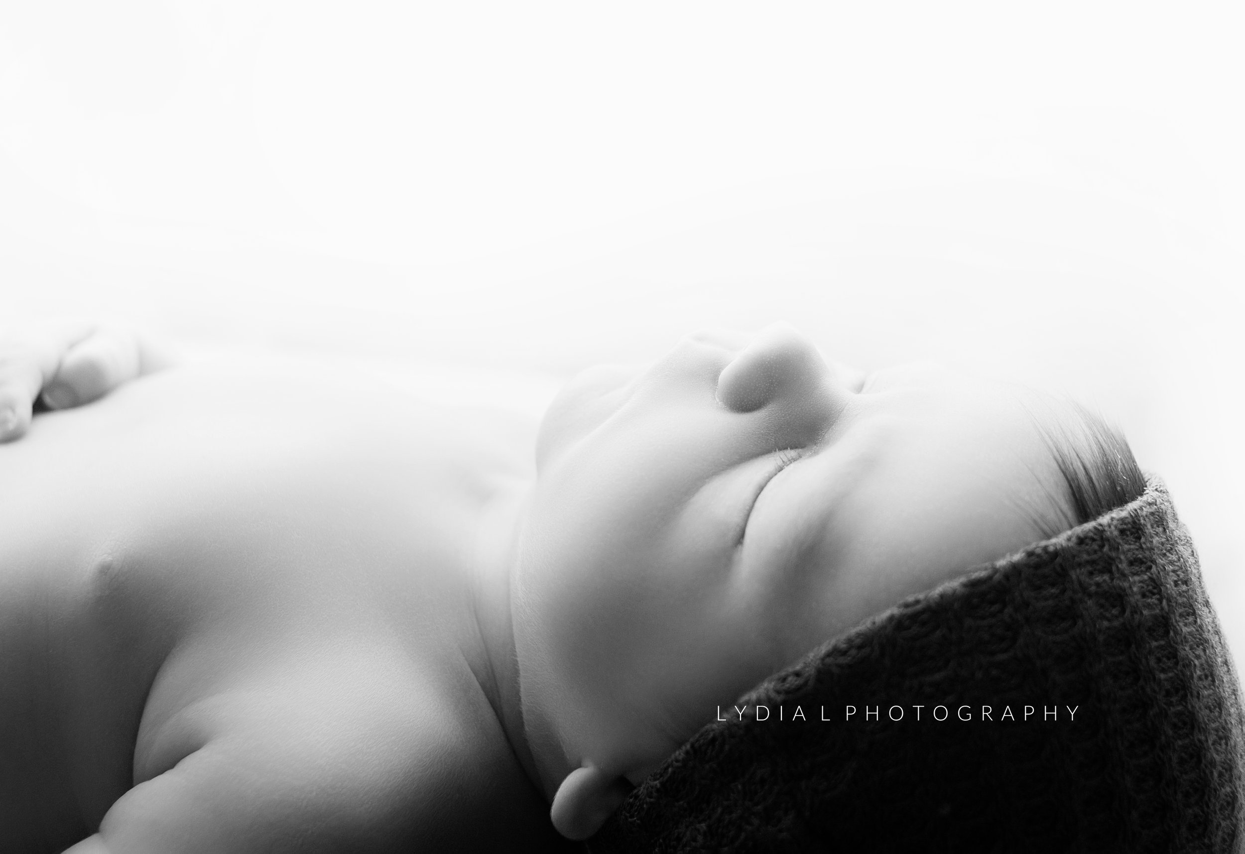 side profile photo of newborn baby boy, during newborn photoshoot in brentwood tennessee photography studio