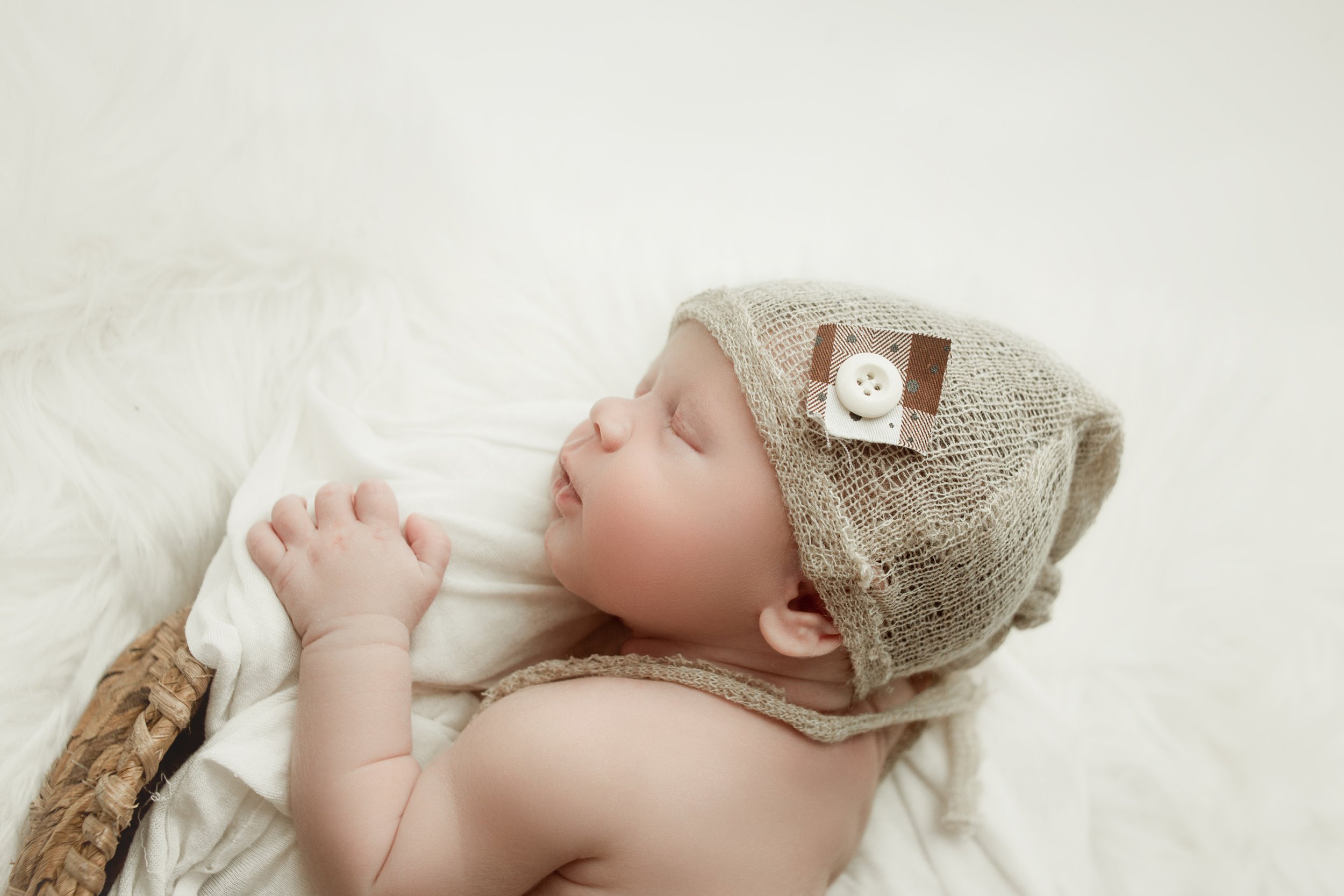 newborn baby boy, sleeping in wicker basket during newborn photoshoot in mount juliet tennessee photography studio , near me
