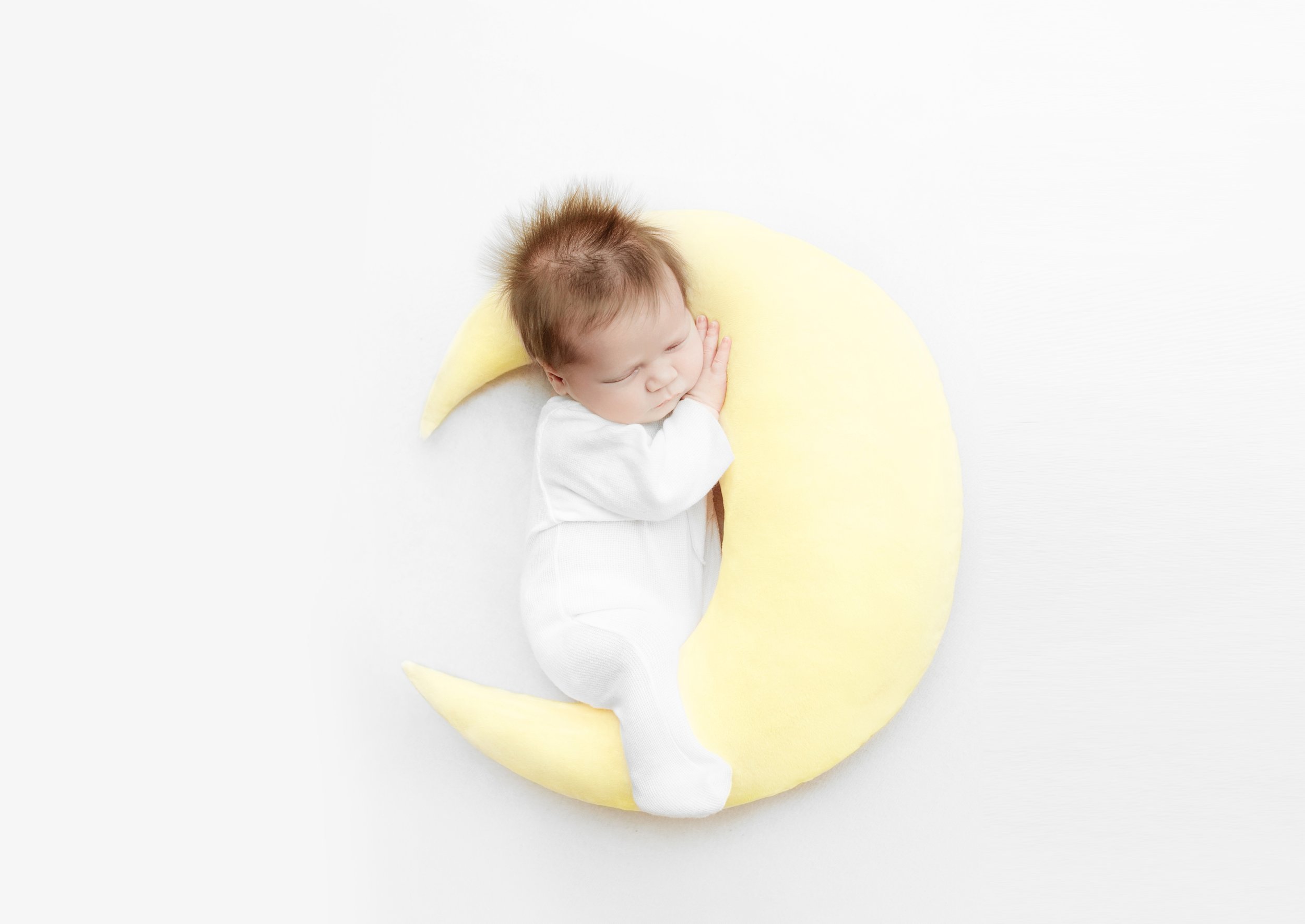 newborn baby boy, sleeping on moon pillow during newborn photoshoot, in mount juliet tennessee photography studio