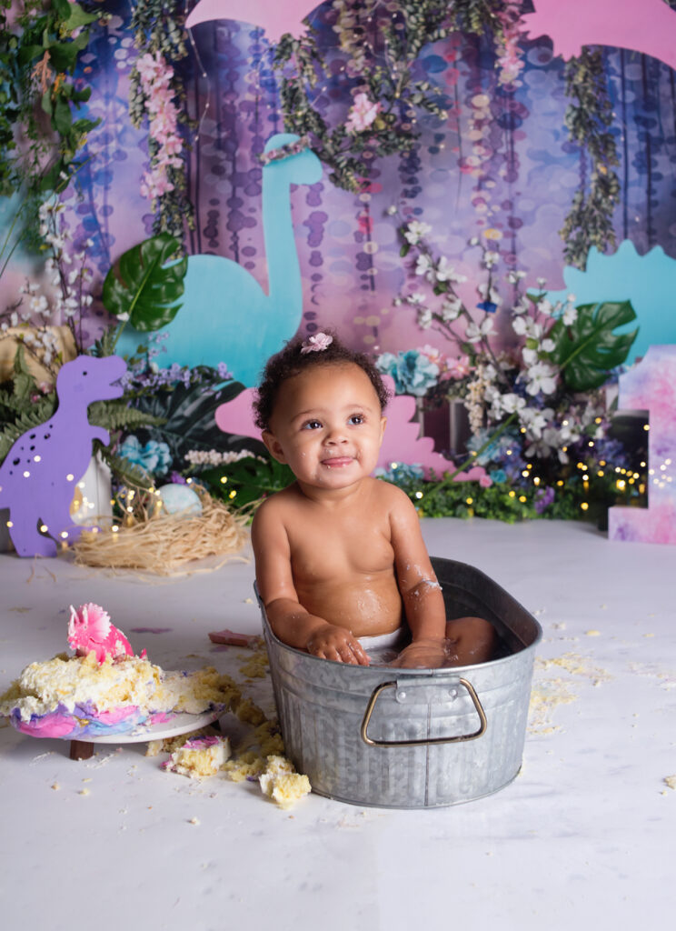 Little girl sitting in metal tub during cake smash photoshoot in Mount Juliet tennessee photography studio 