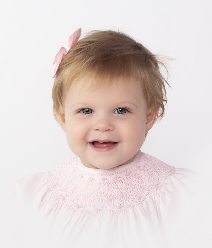 Little girl wearing pink dress and pink bow during heirloom photoshoot with Nashville, TN Photography studio 