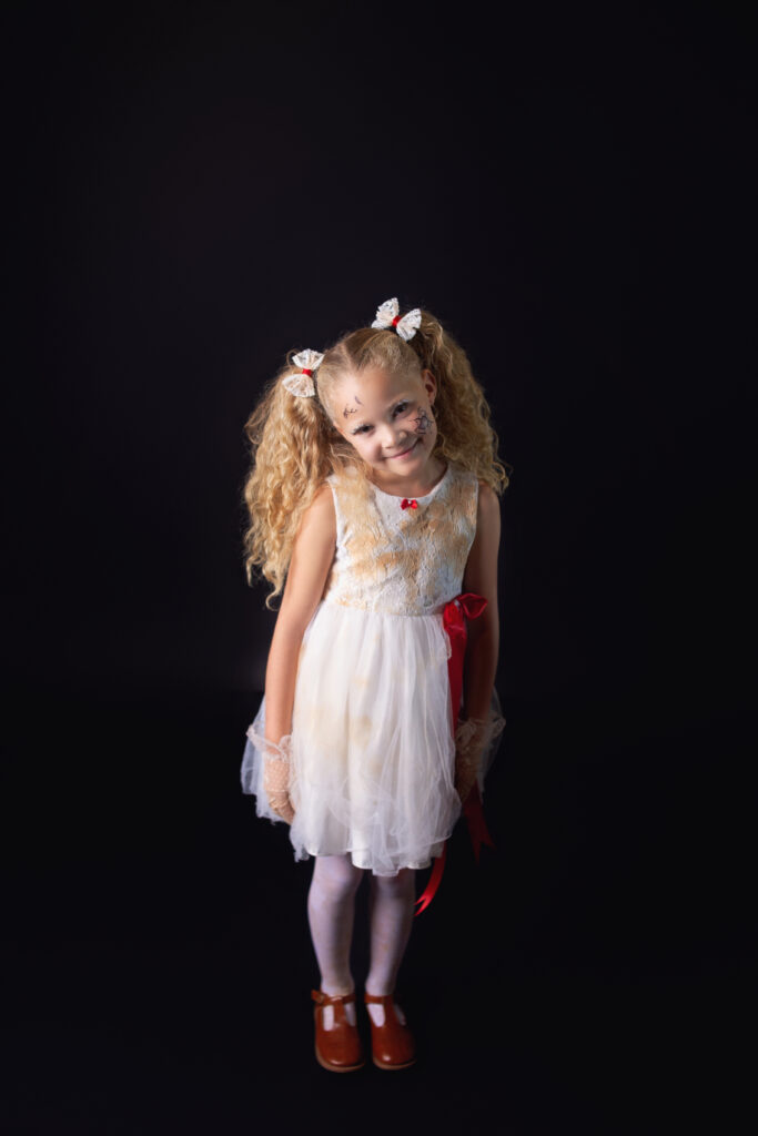 Little girl dressed as creepy doll during Halloween mini session photoshoot with Nashville, TN photographer in Mount Juliet, TN Photography studio 