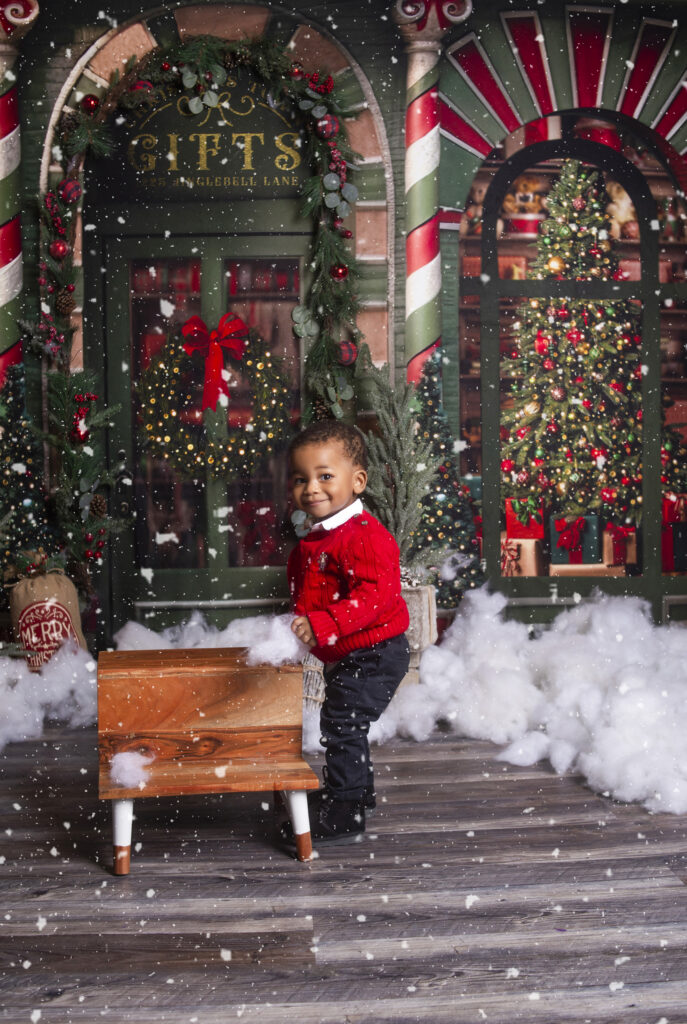 Little boy standing next wood stool during Christmas mini session photoshoot with Mount Juliet, TN photographer 