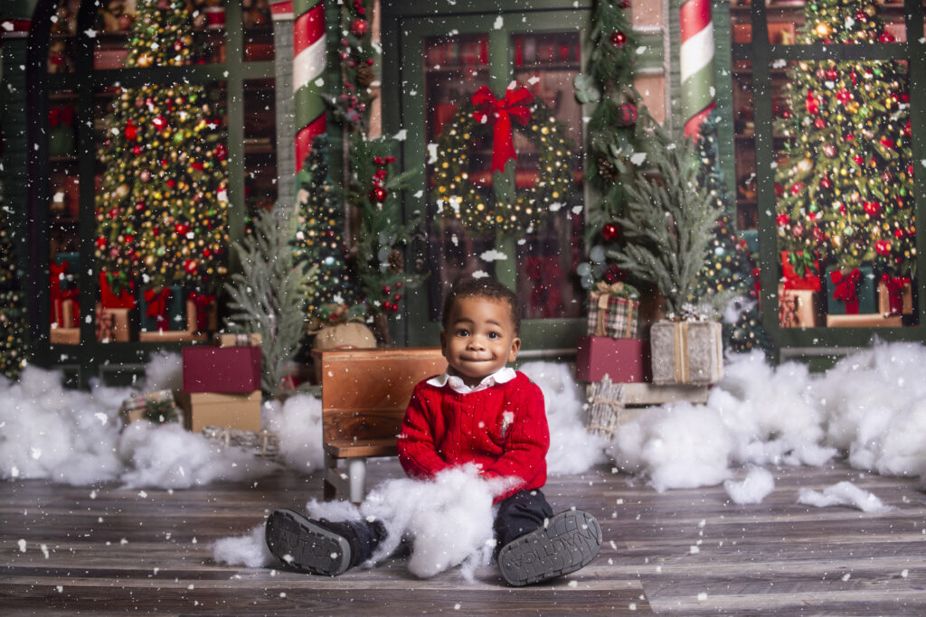 Baby boy sitting during Christmas mini session photoshoot with Nashville, TN Photographer 