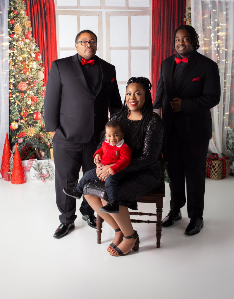 family posing for Christmas photo during Christmas mini session photoshoot with Nashville TN Photographer in Mount, Juliet TN Photography studio 