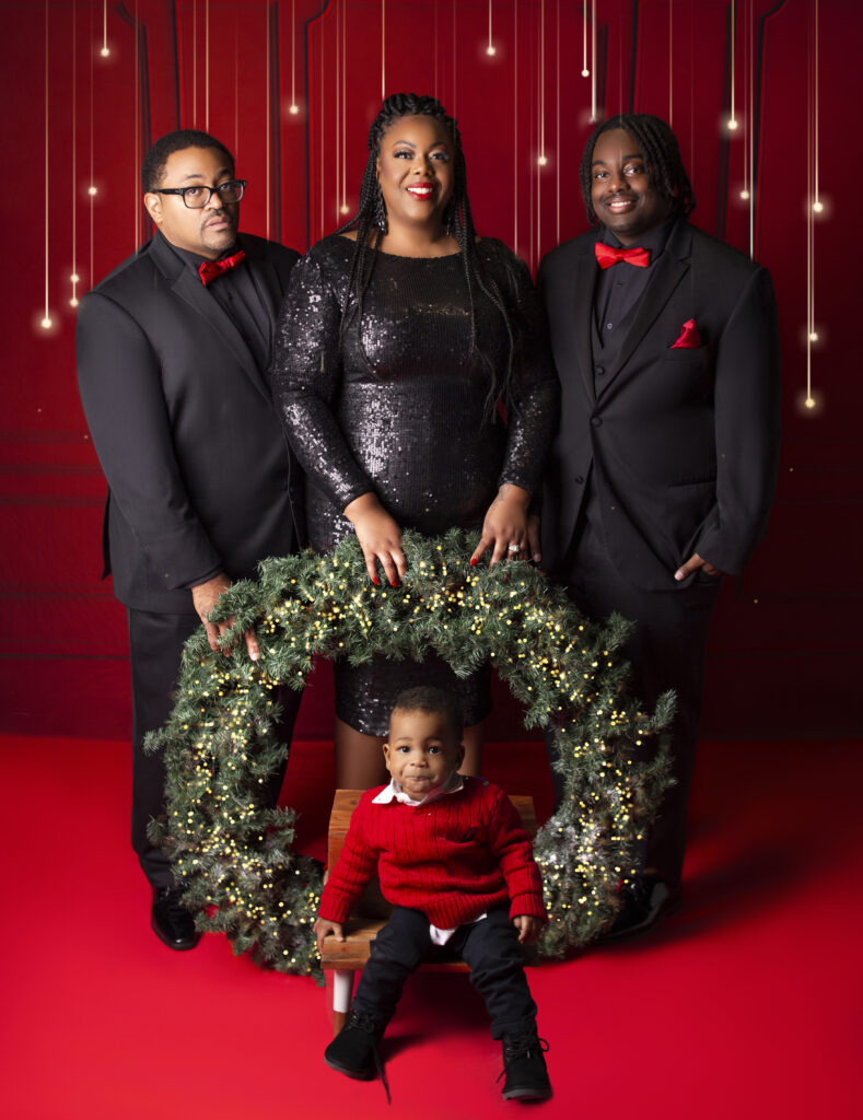 Family dressed formal for Christmas mini session photoshoot with giant wreath with Mount Juliet, TN photographer