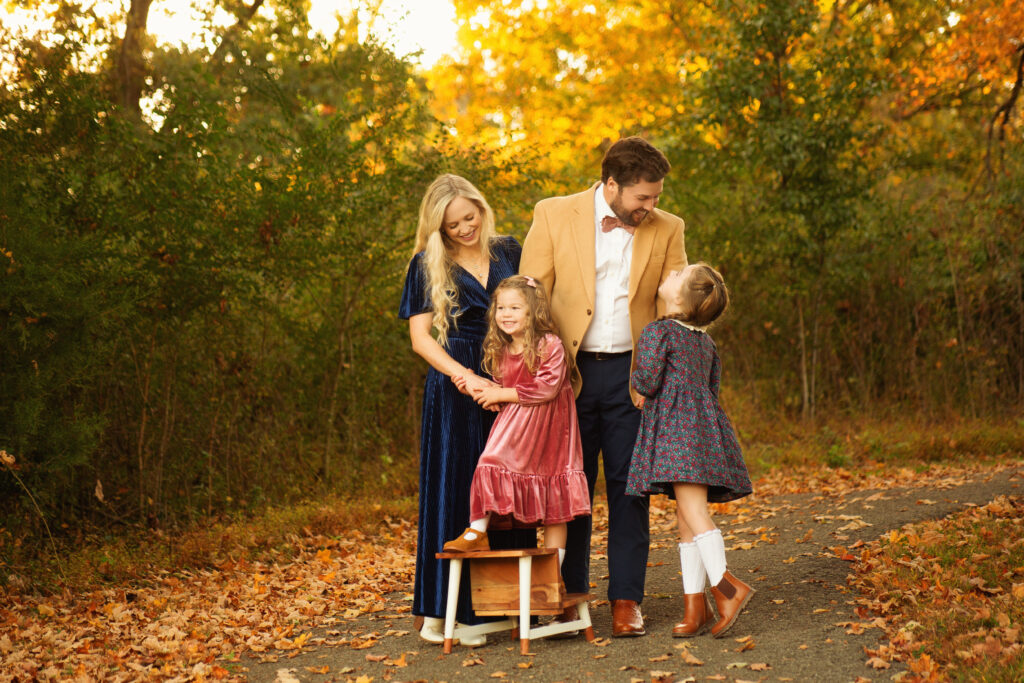 Family laughing with daughters and mother and father during fall mini session photoshoot with Mt. Juliet TN photographer