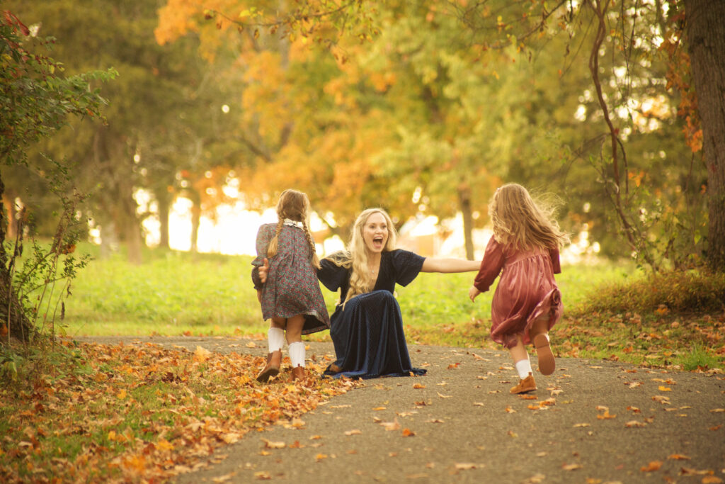 Two daughters running to their mom during Fall mini session photoshoot with Nashville, TN 