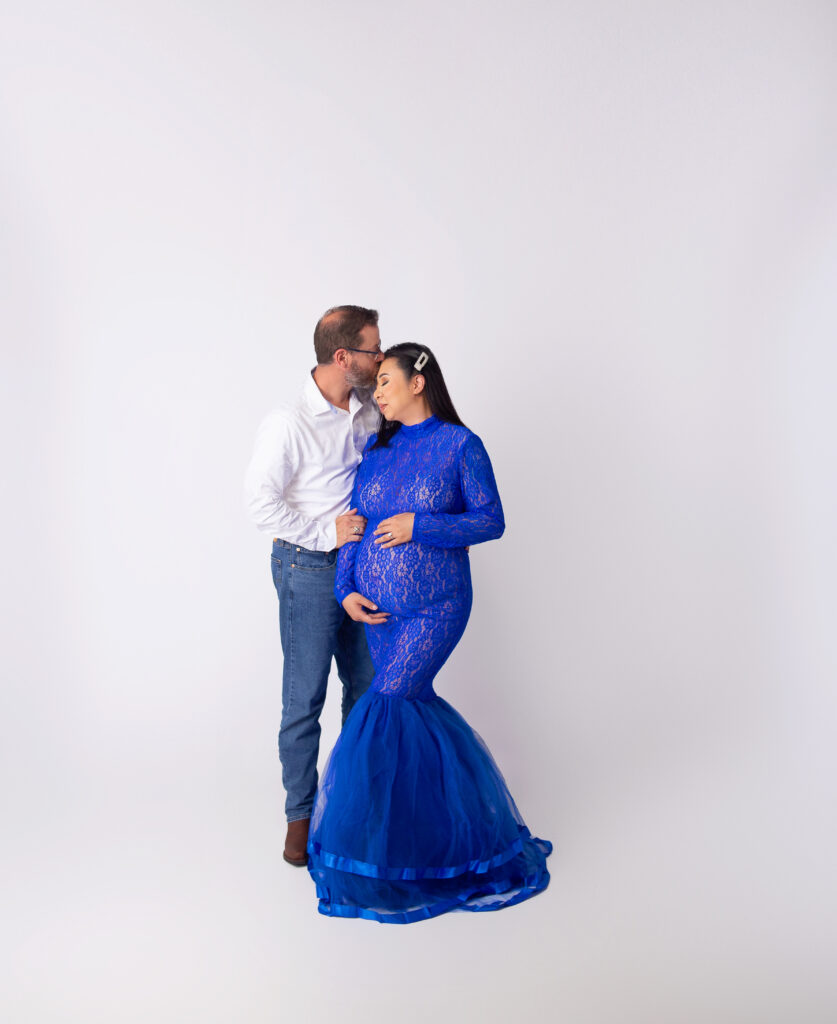 Husband kissing pregnant wife on head during maternity photoshoot with Nashville, TN maternity photographer 