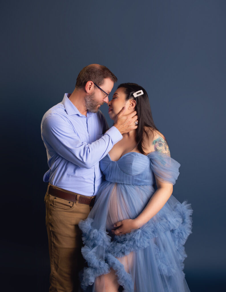 Husband and wife kissing during maternity photoshoot with Mount Juliet, TN maternity photographer 